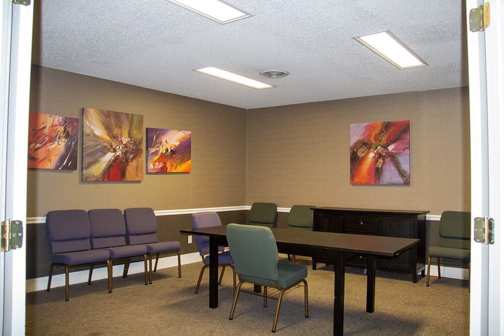 Conference room with table and chairs and abstract artwork hanging on the walls