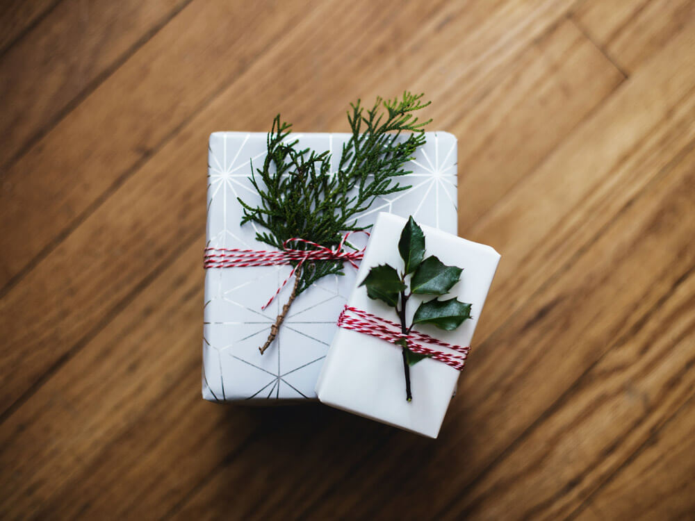Gift wrapped packages with sprigs of greenery