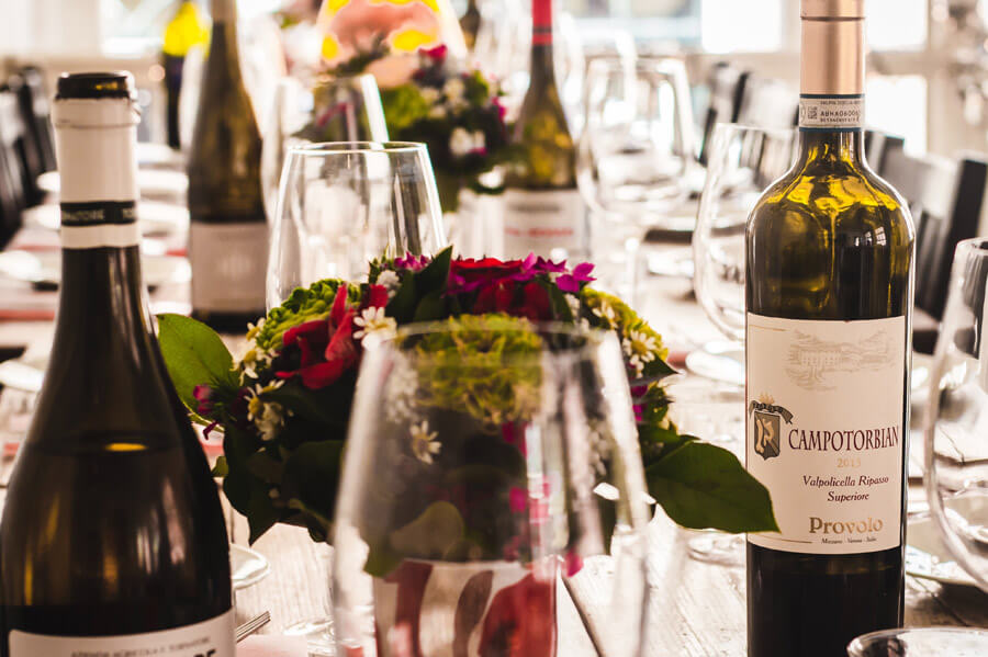 Wine bottles and placesettings at table